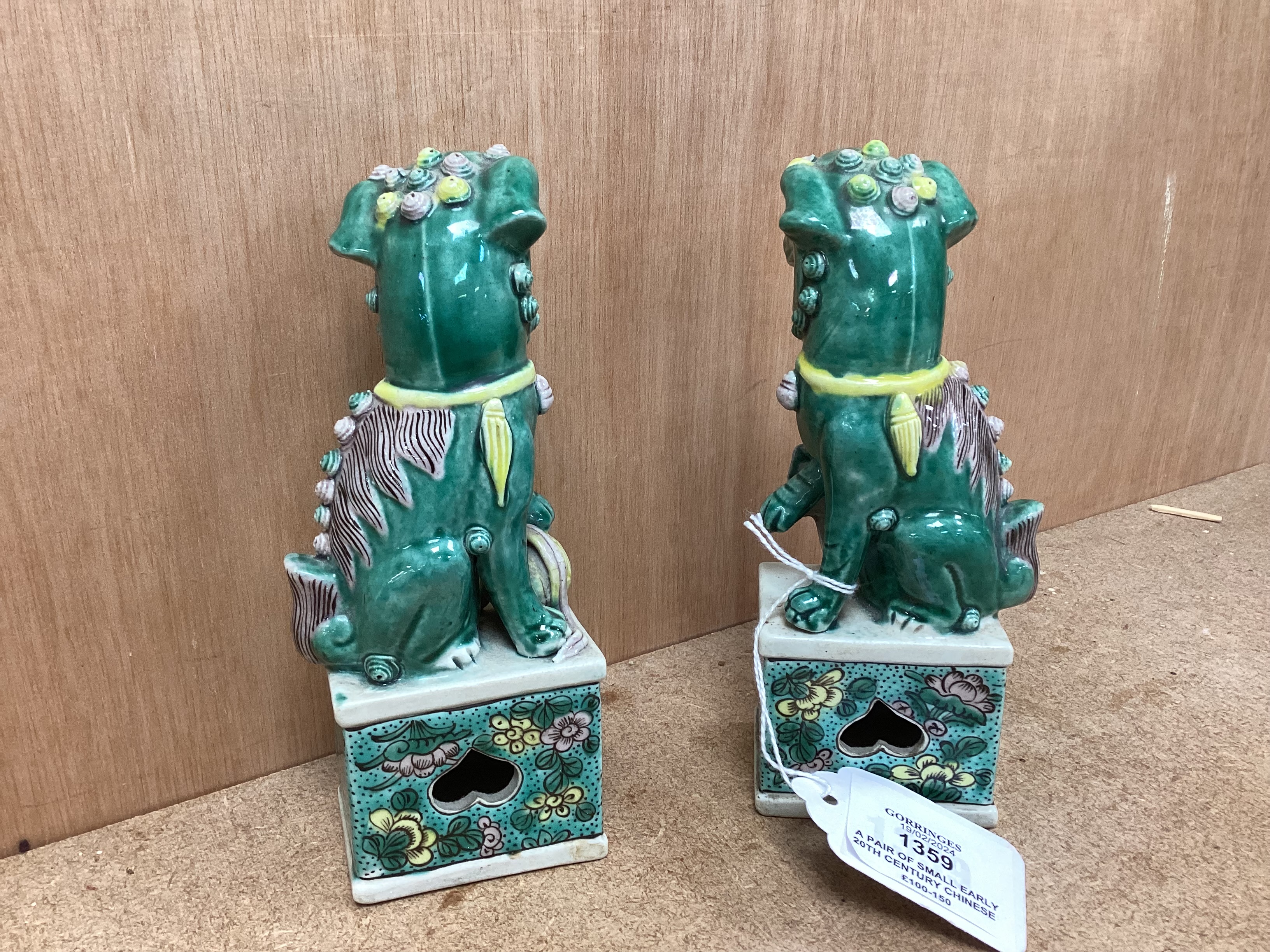 A pair of small early 20th century Chinese figures of Buddhist lions, 15.5cm high